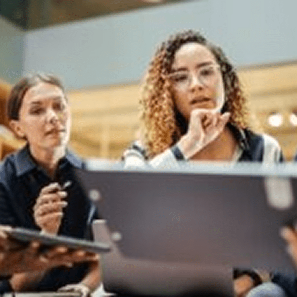 Group focused on a laptop screen