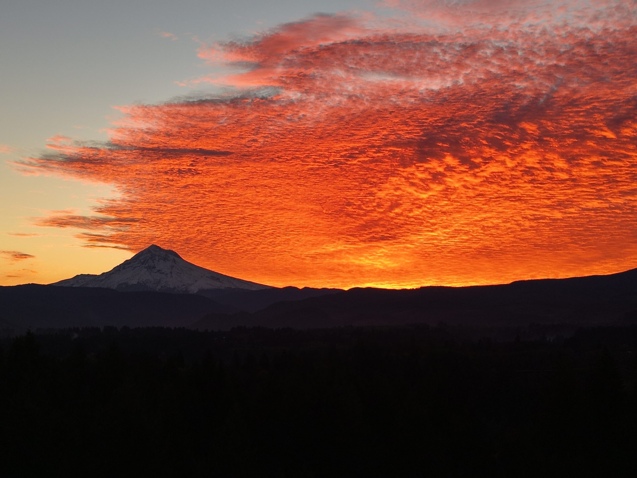 Fiery sunset over mountain silhouette