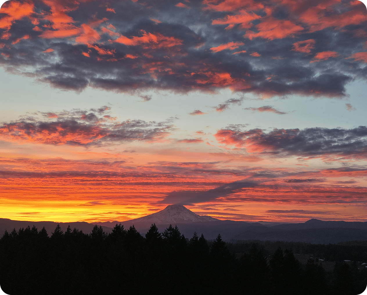 Vibrant sunset over mountain silhouette